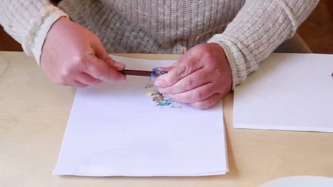 Boy draws drawing and mum sharpens pencils Stock Footage 76704595