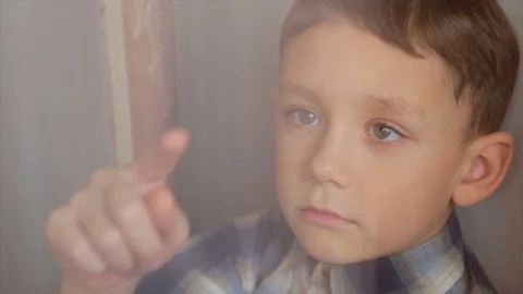 The boy draws a finger on the window Stock Footage 84926600