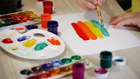 The boy draws in gouache on a white sheet of paper. Concept of drawing Stock Footage 153867108