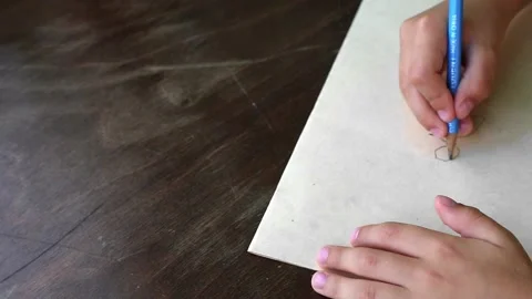 A boy draws a horse with a pencil. The process of creating a drawing Stock Footage 213270176