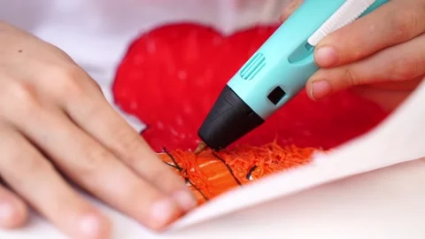 A boy draws or plays with a 3D pen Stock Footage 267943090