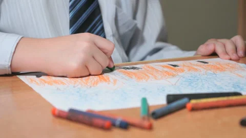 Boy draws pictures using color chalks and pencils Stock Footage 89233247