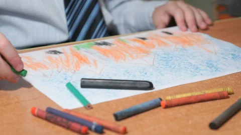 Boy draws pictures using color chalks and pencils Stock Footage 90919208