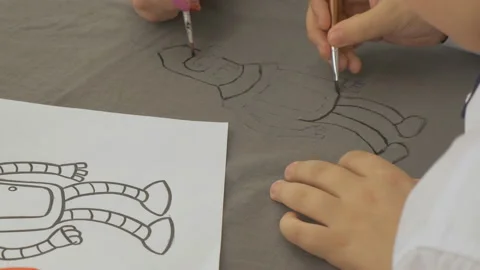 Boy draws a robot on paper Stock Footage 107255410