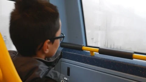 The boy draws a smiley face on the bus window. Happy. Stock Footage 83296961