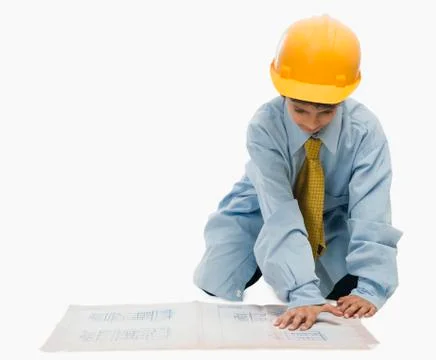Boy dressed as an architect and working on a blueprint Stock-Fotos