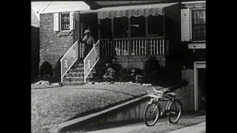 A boy dressed as a cowboy hops on his bicycle and races to the market to buy Stock Footage 106906164