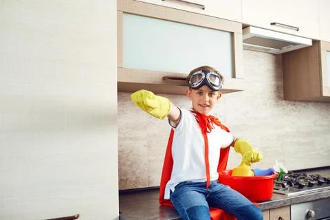 A boy dressed as a superhero in the kitchen Fotos de archivo