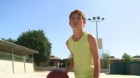 Boy dribbles basketball Stock Footage 22214406