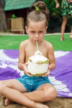 Boy drinking coconut Stock-Fotos