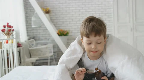 Boy drinking cough syrup 스톡 동영상 22916844
