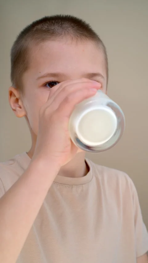 Boy drinking fresh organic yogurt from glass Stock Footage 329024983