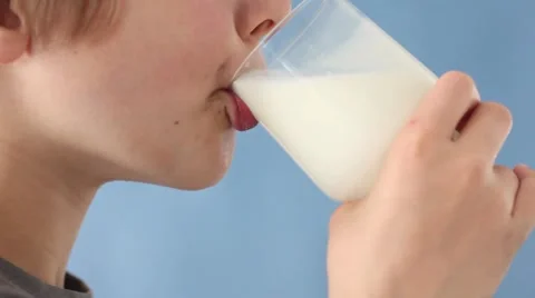 Boy drinking a glass of milk 스톡 동영상 8571782