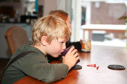 Boy drinking hot chocolate Stock Photos