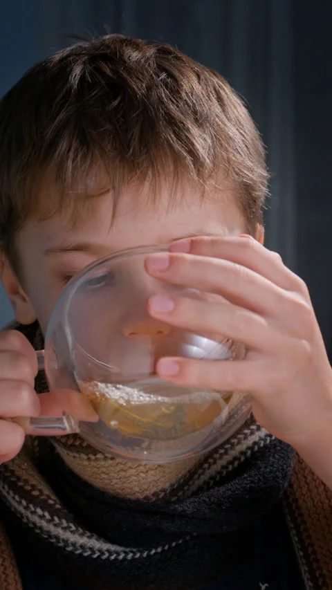 Boy drinking hot tea close-up Stock Footage 325629311