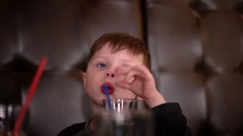 Boy Drinking Juice and Eating Pizza in Cafeteria Stock Footage 62469626
