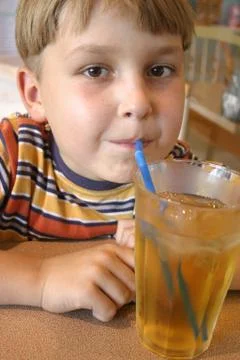 Boy drinking a juice Stock Photos