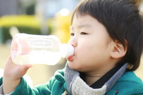 Boy drinking juice Stock Photos