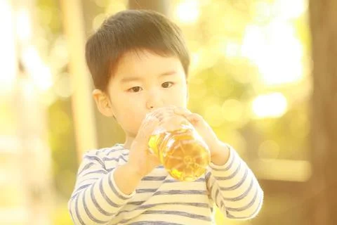 Boy drinking juice Stock Photos