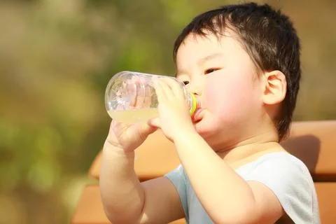 Boy drinking juice Stock Photos