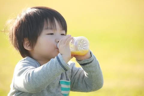 Boy drinking juice Stock Photos