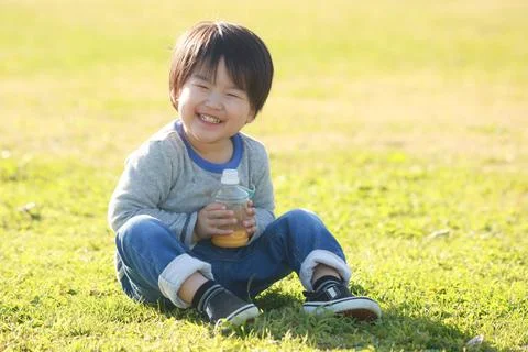 Boy drinking juice Stock Photos