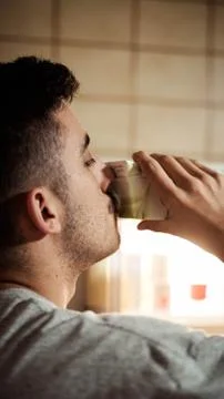 Boy drinking milk from the fridge Фото