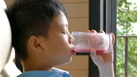 Boy drinking mixed berries and vegetables juice Stock Footage 81227028