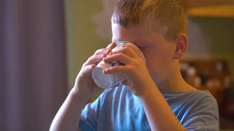 Boy Drinking out of a Disposable Cup Stock Footage 94396590
