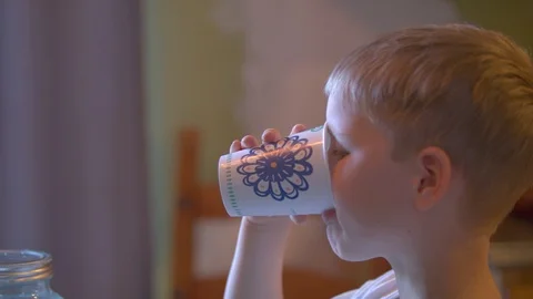 Boy Drinking out of a Disposable Cup and Spilling on His Chin Stock Footage 94396997