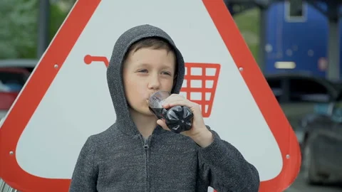 The boy is drinking from a plastic bottle, slow motion Stock Footage 107554582