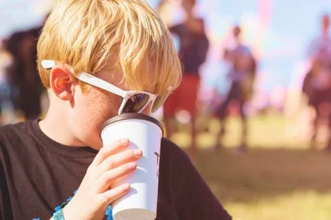 Boy drinking from a plastic cup Stock Photos