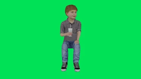 The boy is drinking something in a sitting position from the angle facing Stock-Footage 246731195