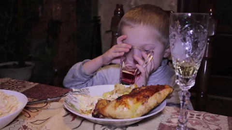Boy drinking at the table Video stock 55815558