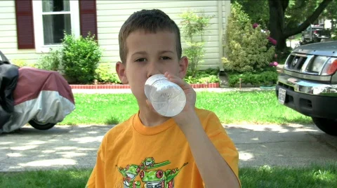 Boy drinking water from bottle Видео 500858