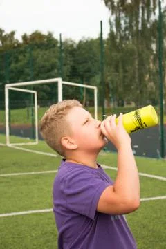 Boy drinking water from bottle Foto stock