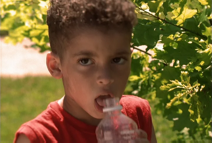 Teen boy drinking water outdoors Stock Video Footage by ©VaLiza #199836560