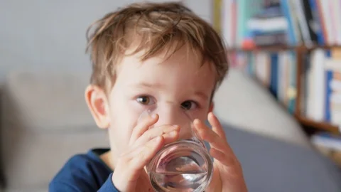 Boy drinking water from glass Video stock 87123486