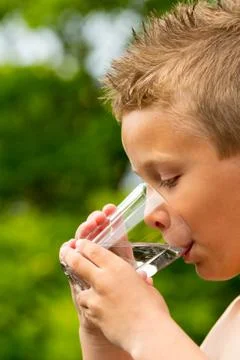 Boy drinking water Stock Photos