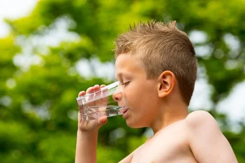 Boy drinking water Stock Photos