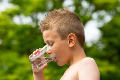 Boy drinking water Stock Photos
