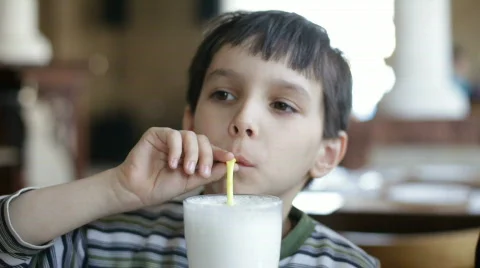 The boy drinks a cocktail Stockbeeldmateriaal 677732