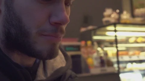Boy Drinks Cup of Coffe in a Coffee Shop Stock Footage 69739286