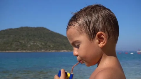 Boy drinks from a straw, Crystal child Stock Footage 65419518