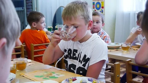 Boy drinks tea from a glass Stock Footage 54514636