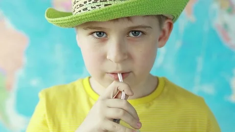  Boy drinks water from a bottle on a background of the world map Stock Footage 76051144