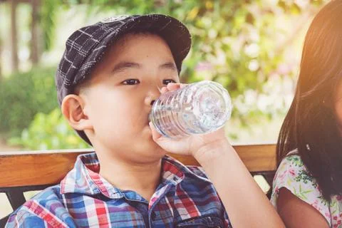 Boy drinks water from a bottle Stock Photos