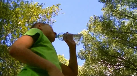 Boy drinks water from a plastic bottle Stock Footage 67859159