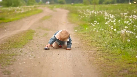 The boy drives a car in the countryside Stock Footage 76288437