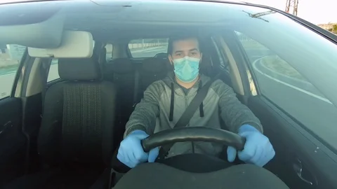 Boy drives the car with mask and protective gloves Stock Footage 129407152
